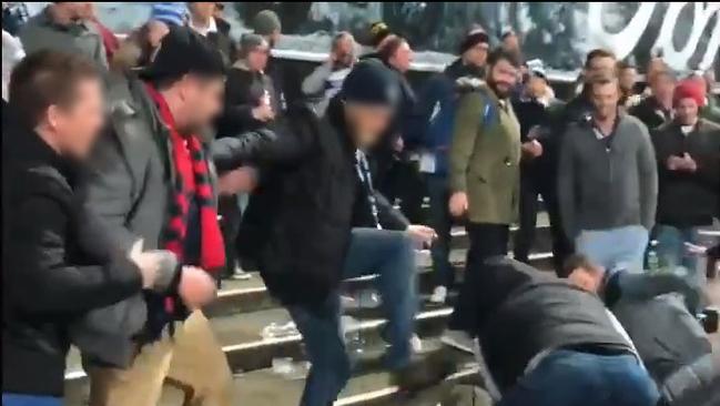 One Geelong fan could be seen attempting to stomp on a Melbourne fan.