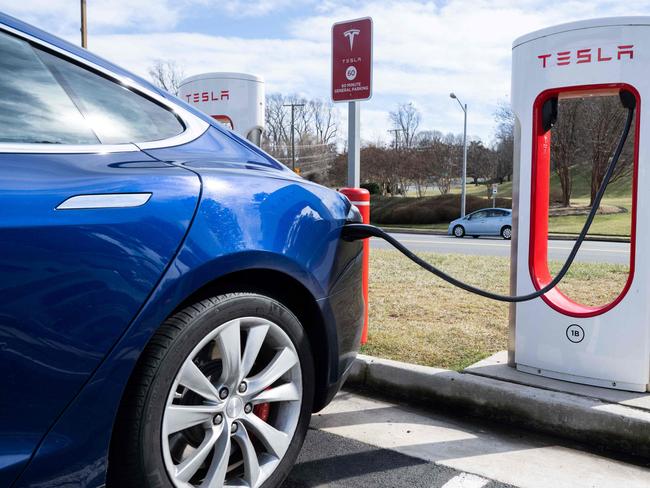 (FILES) A Tesla Model S sedan is plugged into a Tesla Supercharger electrical vehicle charging station in Falls Church, Virginia, February 13, 2023. Tesla reported an 8.5 percent drop in first-quarter auto deliveries on April 2, 2024, missing estimates from leading analysts and weighing on shares. Elon Musk's auto giant reported 386,810 deliveries over the period, reflecting in part a weak market in China, where it faces heavy competition from local electric vehicle makers. Shares fell 5.8 percent in early trading. (Photo by SAUL LOEB / AFP)