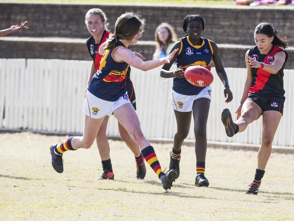Coda Stanmore (right) kicks for South Toowoomba under pressure from Georgia Coonan (left) and Brittany Ladu of University in AFL Darling Downs senior women's round 9 at Heritage Oval, Saturday, June 19, 2021. Picture: Kevin Farmer