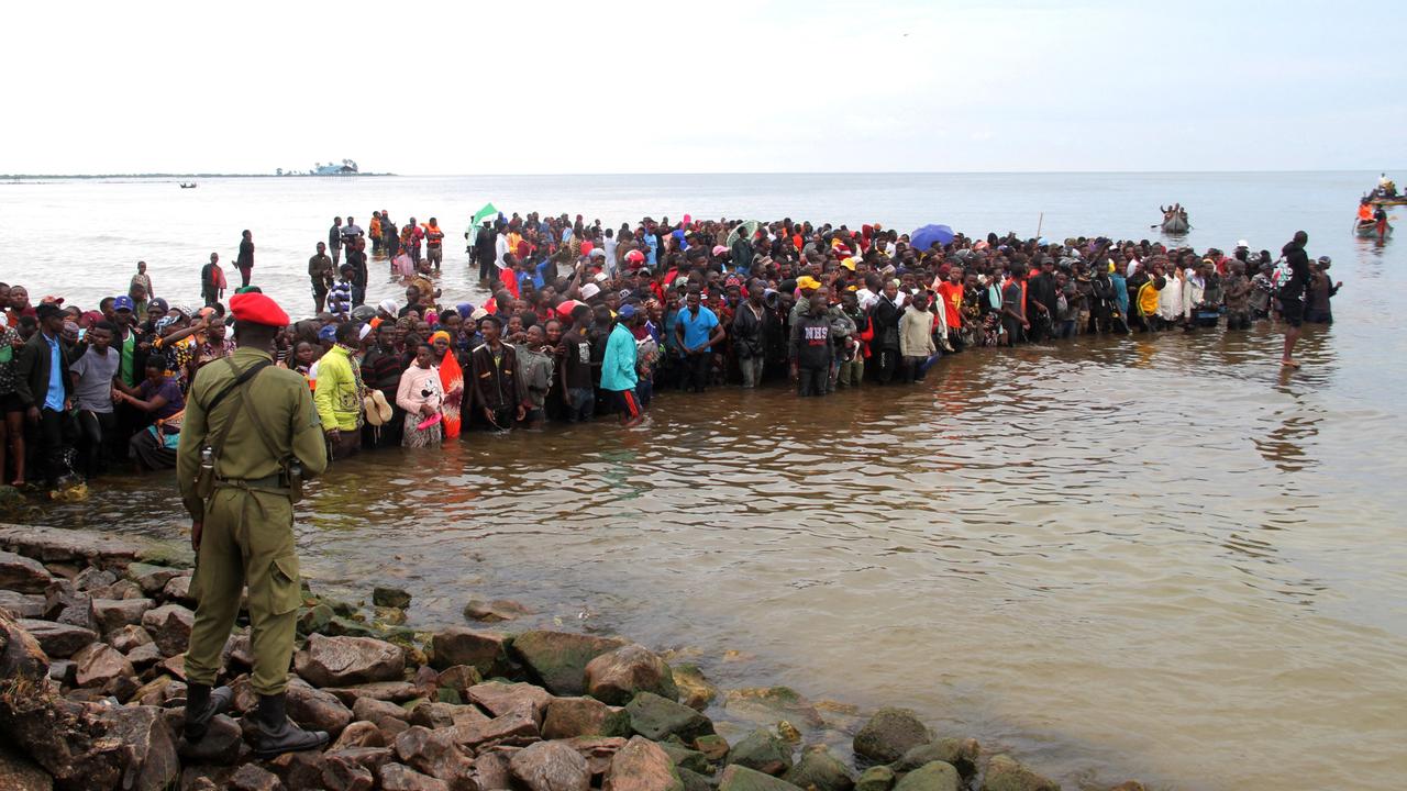 Local residents gather as rescuers search for survivors. Picture: Sitide Protase/AFP