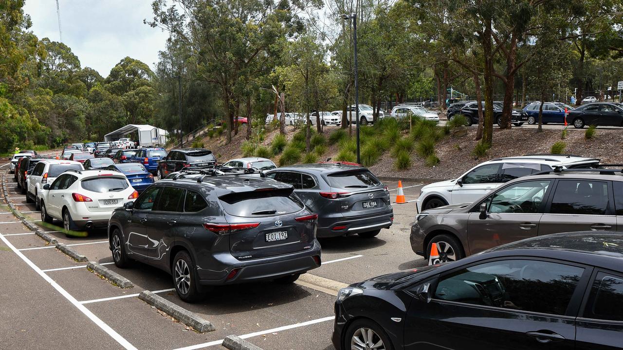 Members of the public are seen queuing at a pop up Covid testing clinic at Willoughby Leisure Centre Drive-through. Picture: NCA NewsWire / Flavio Brancaleone.