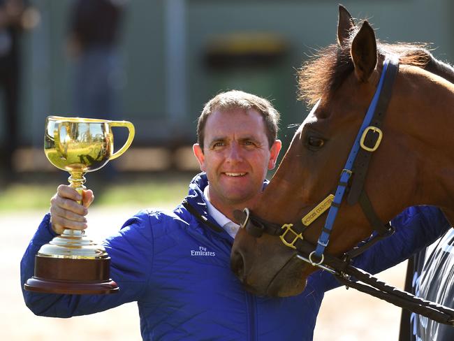 Trainer Charlie Appleby holds the Melbourne Cup in Melbourne on November 7, 2018, a day after the British horse Cross Counter won the 5.30 million USD race in Melbourne. (Photo by William WEST / AFP)