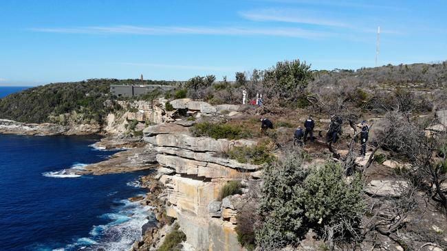 NSW Police search an area on North Head on Tuesday looking for evidence that may assist in the investigation into the death of Scott Johnson. Picture: Toby Zerna