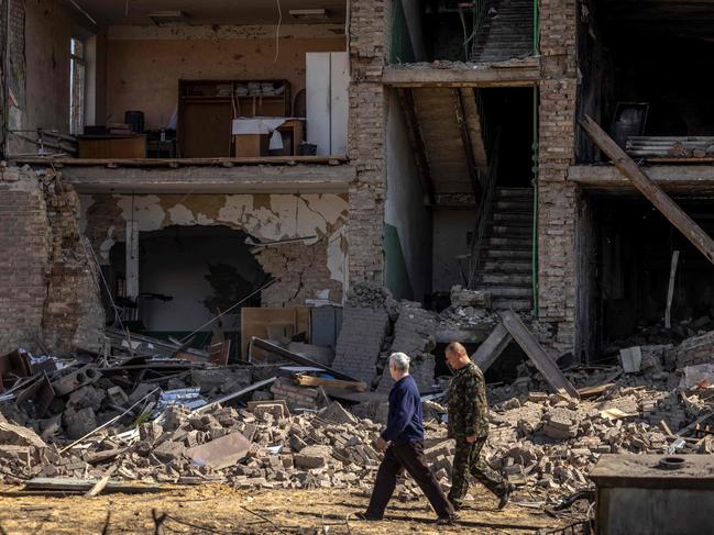 People walk past a Ukrainian military factory outside Kyiv that produced missiles allegedly used to hit Russia's Moskva warship. Picture: AFP