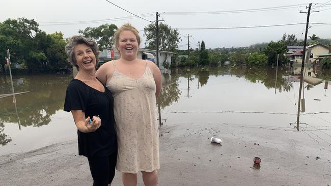 Lismore residents Linda Kelly (left) and her daughter Evanna Kelly put on a brave face on March 1, 2022, after both of their homes were inundated with flood water.