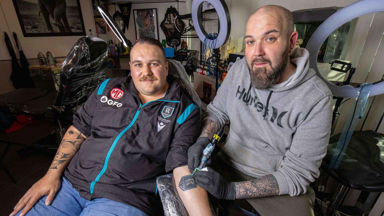 Gavin Lawrence getting his touch up port tattoo from artist Dylan Glacken. Picture: Ben Clark