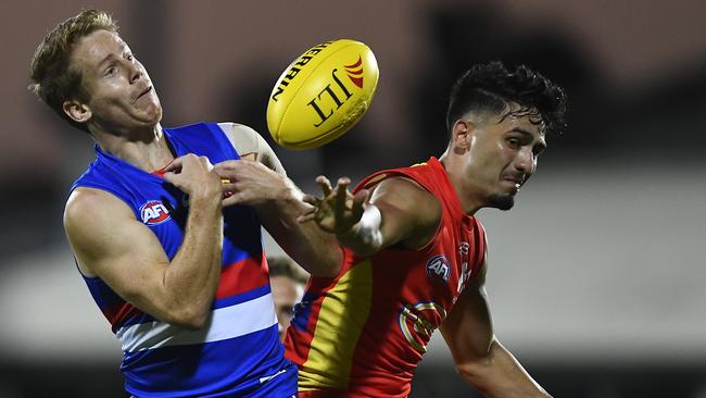 Lachie Hunter spills a mark with pressure from Suns youngster Izak Rankine. Picture: Getty Images