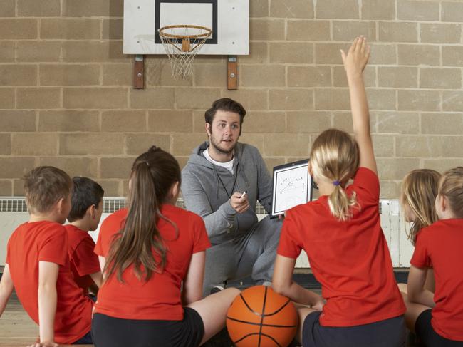 Coach Giving Team Talk To Elementary School Basketball Team . iStock