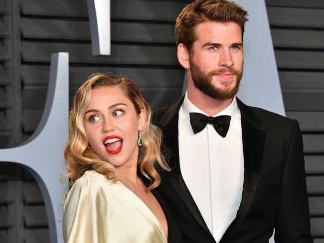 Miley Cyrus and Liam Hemsworth looked loved up as they posed for photos. Picture: AFP
