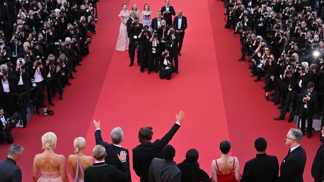 The cast and crew wave to the crowd below from the top of the stairs. Picture: Antonin Thuillier/AFP