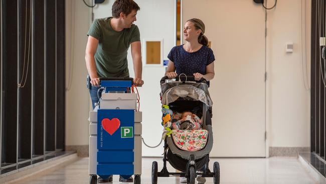 Andrew and Kylie walking Ellie and her heart machine in the hospital. Picture: Jason Edwards