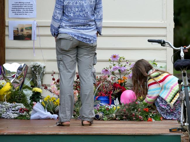 People leave tributes at the home where the tragedy occurred. Picture: Sharon Smith