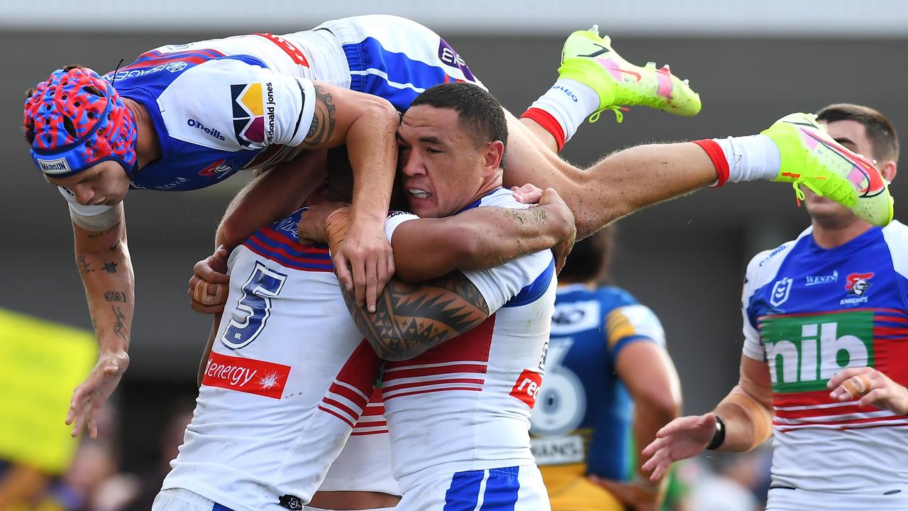 Kalyn Ponga of the Knights (top) celebrates a try (Photo by Albert Perez/Getty Images)