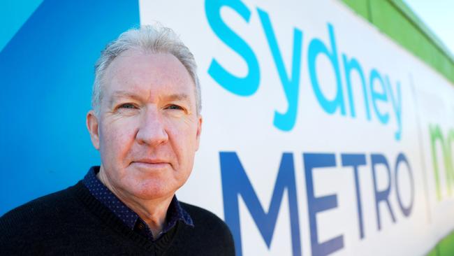 Peter Townend poses for photographs in front of the construction works at Cherrybrook Station. Cherrybrook, Saturday, July 21st 2018. Peter Townend wants answers over the Cherrybrook Station Precinct. Residents have been waiting for a decision to be handed down for the past 5 years. (AAP Image / Angelo Velardo)