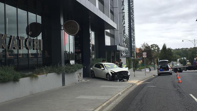 The car came to a stop on the footpath after riccocheting off The Chen’s wall.