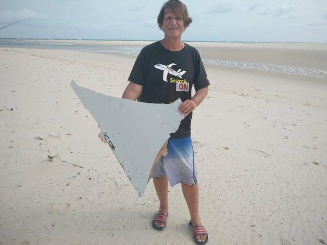 Blaine Gibson with the suspected aircraft horizontal stabiliser, which is being investigated for links to MH370, near where he found the object. The words ‘NO STEP’ can clearly be seen along one edge.