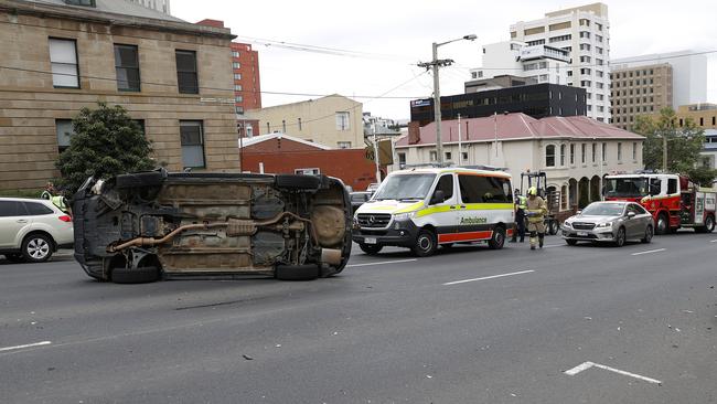 Emergency services were called to a car crash on Davey Street where a car was flipped on its side. Picture: Zak Simmonds