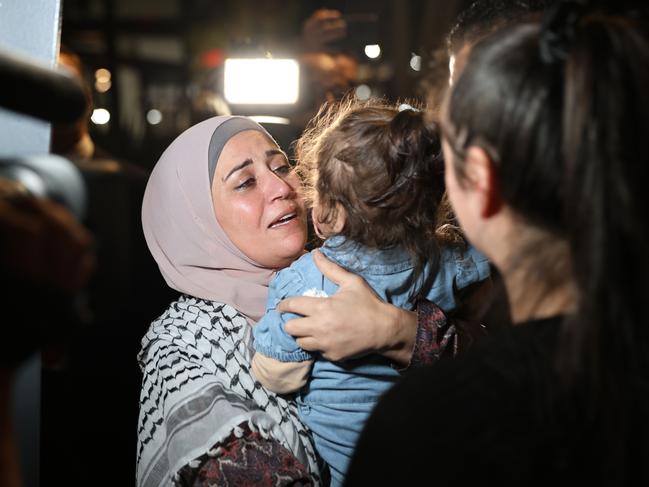 Mona, a mother from Sydney, embraces her friends and family as she arrives at Sydney Airport after fleeing from Gaza. Picture: Damian Shaw