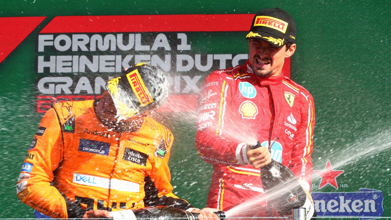 ZANDVOORT, NETHERLANDS - AUGUST 25: Race winner Lando Norris of Great Britain and McLaren and third placed Charles Leclerc of Monaco and Ferrari celebrate in parc ferme after the F1 Grand Prix of Netherlands at Circuit Zandvoort on August 25, 2024 in Zandvoort, Netherlands. (Photo by Joe Portlock/Getty Images) *** BESTPIX ***