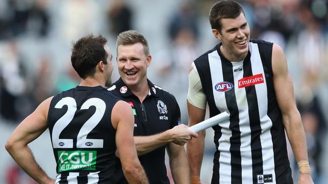 Pie pair Steele Sidebottom and Mason Cox, pictured with coach Nathan Buckey, missed training on Tuesday, but Collingwood says they will both play against the Tigers. Picture: Getty Images