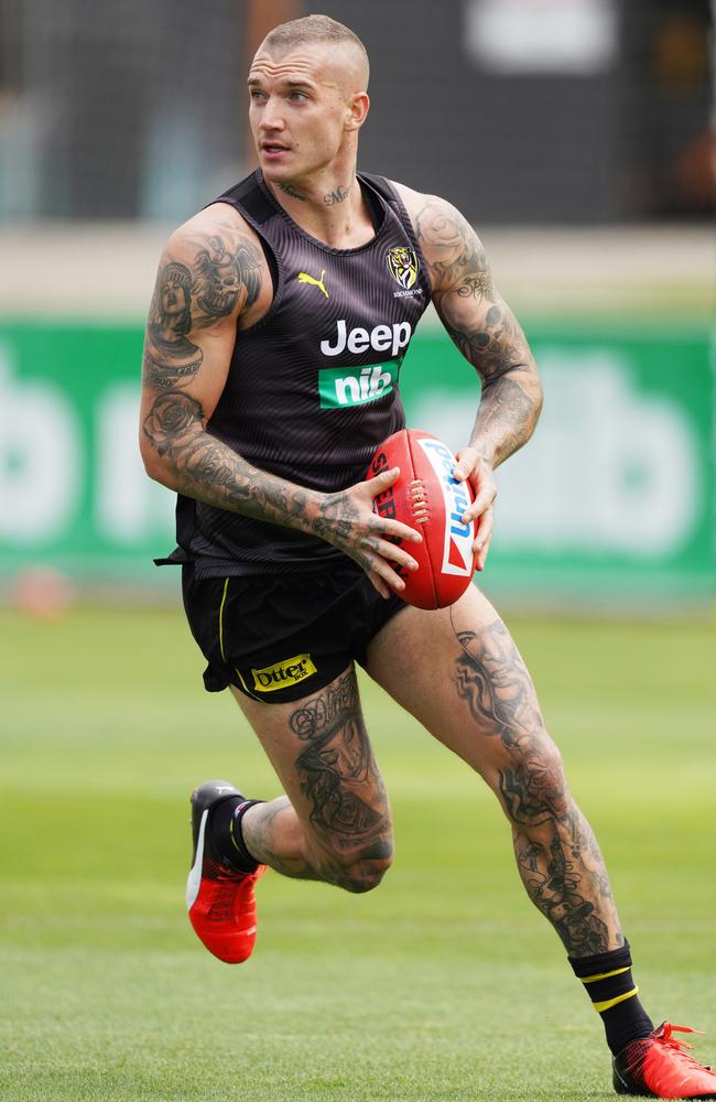 Dustin Martin of the Tigers has a mix of mysterious female portraits emblazoned over his skin. Picture: AAP