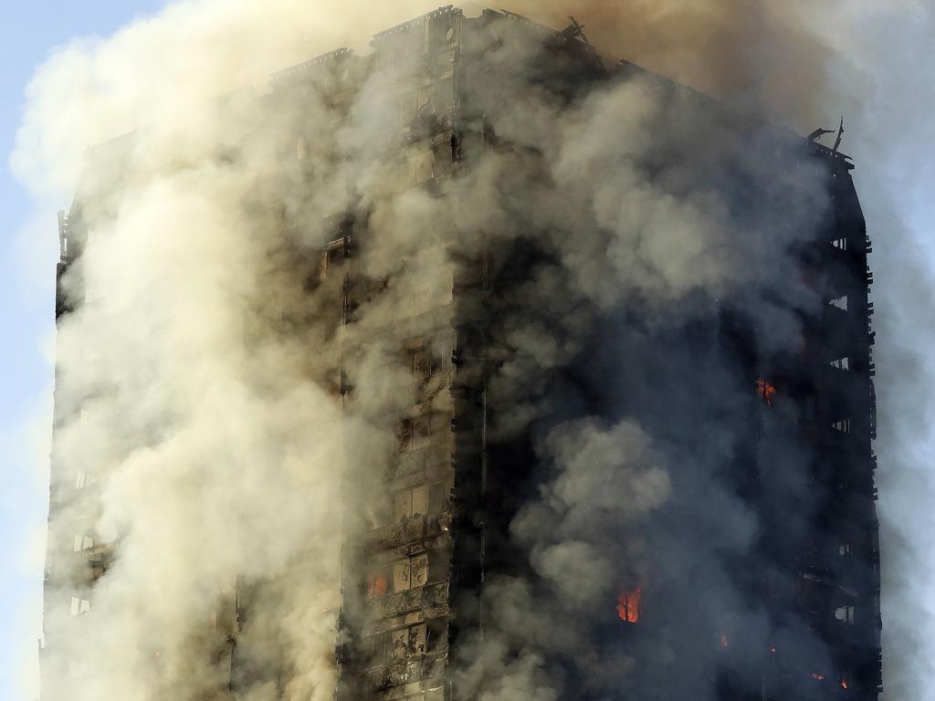 Smoke rises from the apartment building in west London on Wednesday, June 14, 2017. Metropolitan Police are continuing to evacuate people from the tower. The fire has been burning for more than three hours and stretches from the second to the 27th floor of the building. Picture: AP Photo/Matt Dunham