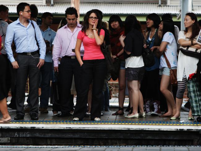 Passengers on Platform 19 of Central Station in Sydney waiting for an overcrowded train service to take them home during evening peak period.