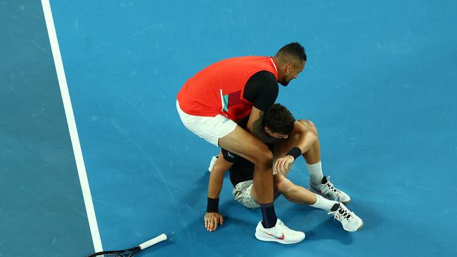 Thanasi Kokkinakis of Australia is picked up by Nick Kyrgios