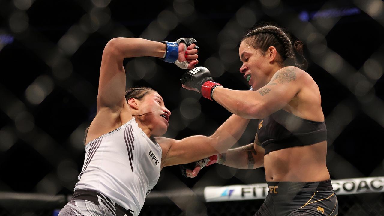 Julianna Pena (L) exchanges punches with Amanda Nunes. (Photo by Carmen Mandato/Getty Images)