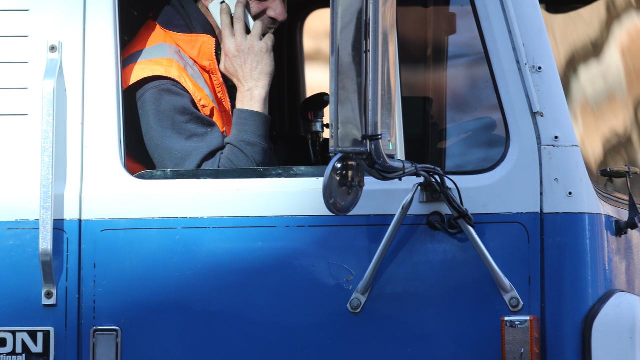 This heavy vehicle driver was snapped talking on his phone while driving around Sydney. Picture: John Grainger