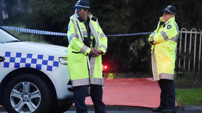 Police stand guard at the scene where the woman’s body was found. Picture: Jake Nowakowski