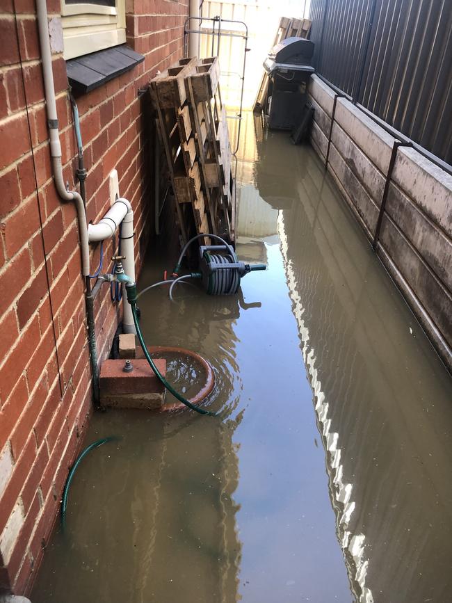 Caitlin Penny’s house was flooded with sewage following a freak sinkhole appearing on her street. Picture: Evangeline Polymeneas