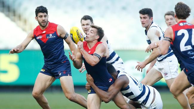 MELBOURNE, AUSTRALIA – JUNE 28: Jack Viney of the Demons handpasses the ball under pressure from Esava Ratugolea of the Cats during the round 4 AFL match between the Melbourne Demons and the Geelong Cats at Melbourne Cricket Ground on June 28, 2020 in Melbourne, Australia. (Photo by Daniel Pockett/AFL Photos/via Getty Images)