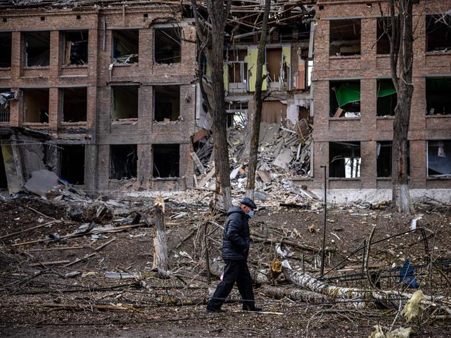 A man walks in front of a destroyed building after a Russian missile attack in the town of Vasylkiv, near Kyiv, on February 27, 2022. Picture: Dimitar Dilkoff/AFP