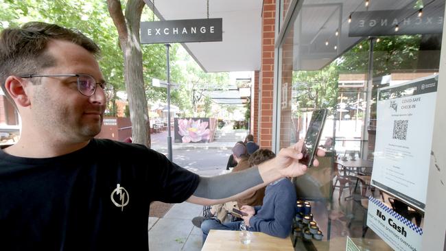 A man scans a QR code as he checks in to a store in December last year, after SA introduced the system. Picture: Kelly Barnes/Getty