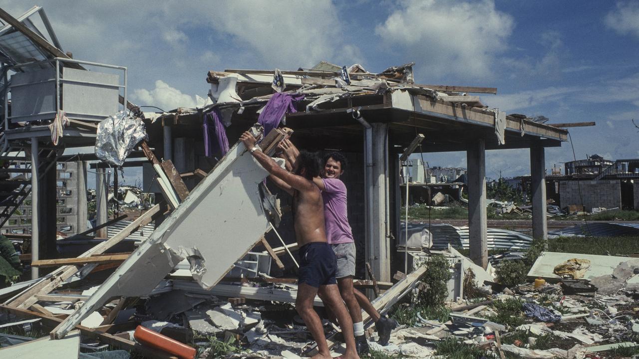 People sifting through rubble of homes after Cyclone Tracy. Supplied/MAGNT