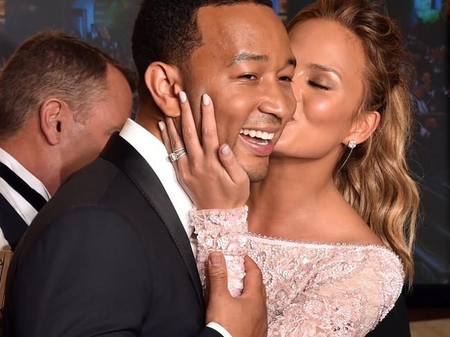 Big chance ... Recording artist John Legend (L), winner of the Golden Globe Best Original Song - Motion Picture for 'Glory' (from 'Selma'), with model Chrissy Teigen. Picture: AFP