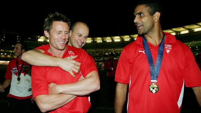 Matthew Nicks gives Swans teammate Stuart Maxfield a hug after the 2005 grand final as Michael O'Loughlin looks on. Nicks and Maxfield missed the win against West Coast through injury.