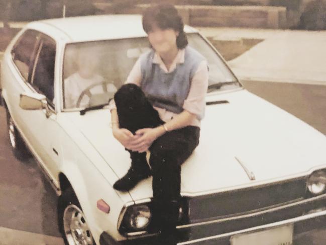 The 18-year-old schoolgirl, who can’t be identified, sitting on the bonnet of her Honda Accord.