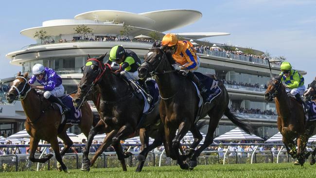 Opie Bosson riding Imperatriz (orange) to victory in the Black Caviar Lightning Stakes at Flemington. Picture: Vince Caligiuri/Getty Images