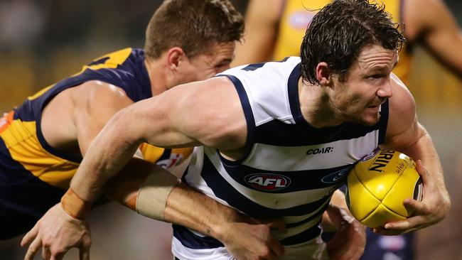 Patrick Dangerfield of the Cats is tackled by Nathan Vardy of the Eagles.