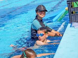 BIG NUMBERS: Jovy Griffin taught Learn2Swim to big numbers yesterday, as the temperature soared to a record. Picture: Alex Treacy