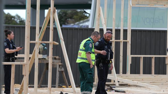 Policed officers and a paramedic at the scene of the accident. Picture: Dylan Coker