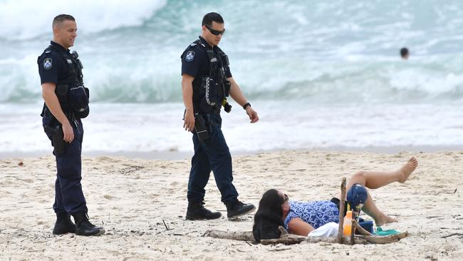 Police have also been spotting moving on sunbathers at Gold Coast beaches. (AAP Image/Darren England)