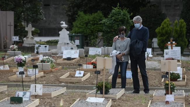 People visit the tomb of a relative at the Monumental Cemetery of Bergamo in Lombardy, Italy. The country has the highest pandemic toll, totalling 64,036 deaths. Picture: AFP