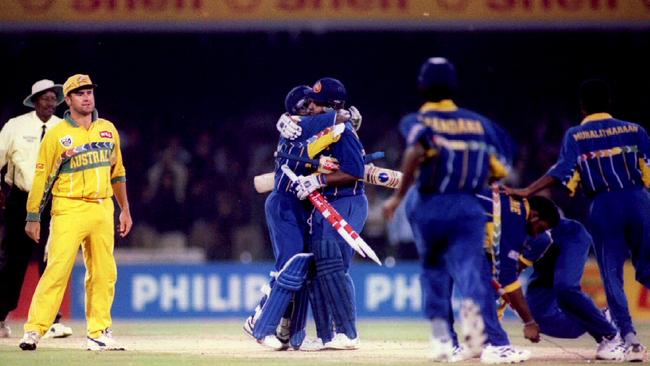 Mark Taylor watches jubilant Sri Lanka players embrace at the end of the 1996 final.