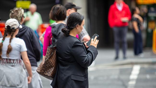 SYDNEY, AUSTRALIA - NewsWire Photos February 06, 2024:  A generic photograph of people on their phone in Sydney.Picture: NCA NewsWire / Christian Gilles