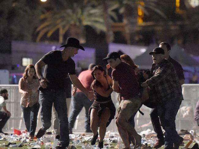 An injured person is helped by fellow concertgoers. Picture: AFP