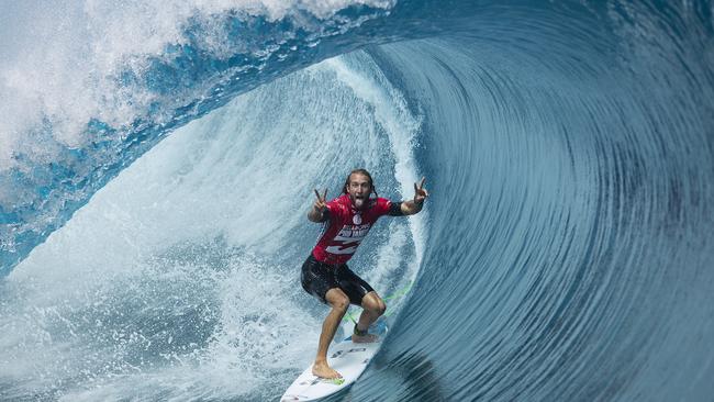 Owen Wright of Lennox Head, NSW, Australia (pictured) gives the double peace sign while surfing inside a huge barrel during Round 5 of the Billabong Pro Tahiti on Monday August 28, 2014. Wright scored a perfect 10 (out of a possible 10) to win his heat over Brett Simpson and has advanced into the Quarterfinals. The Billabong Pro Tahiti will crown a champion later today. Pic: Kirstin Scholtz / ASP