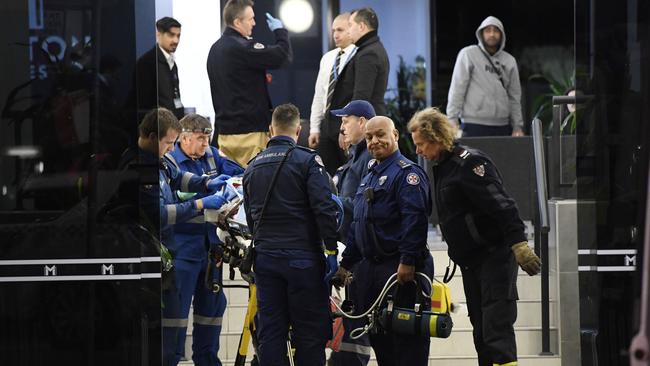 The teenager is loaded into a waiting ambulance. Picture: Gordon McComiskie